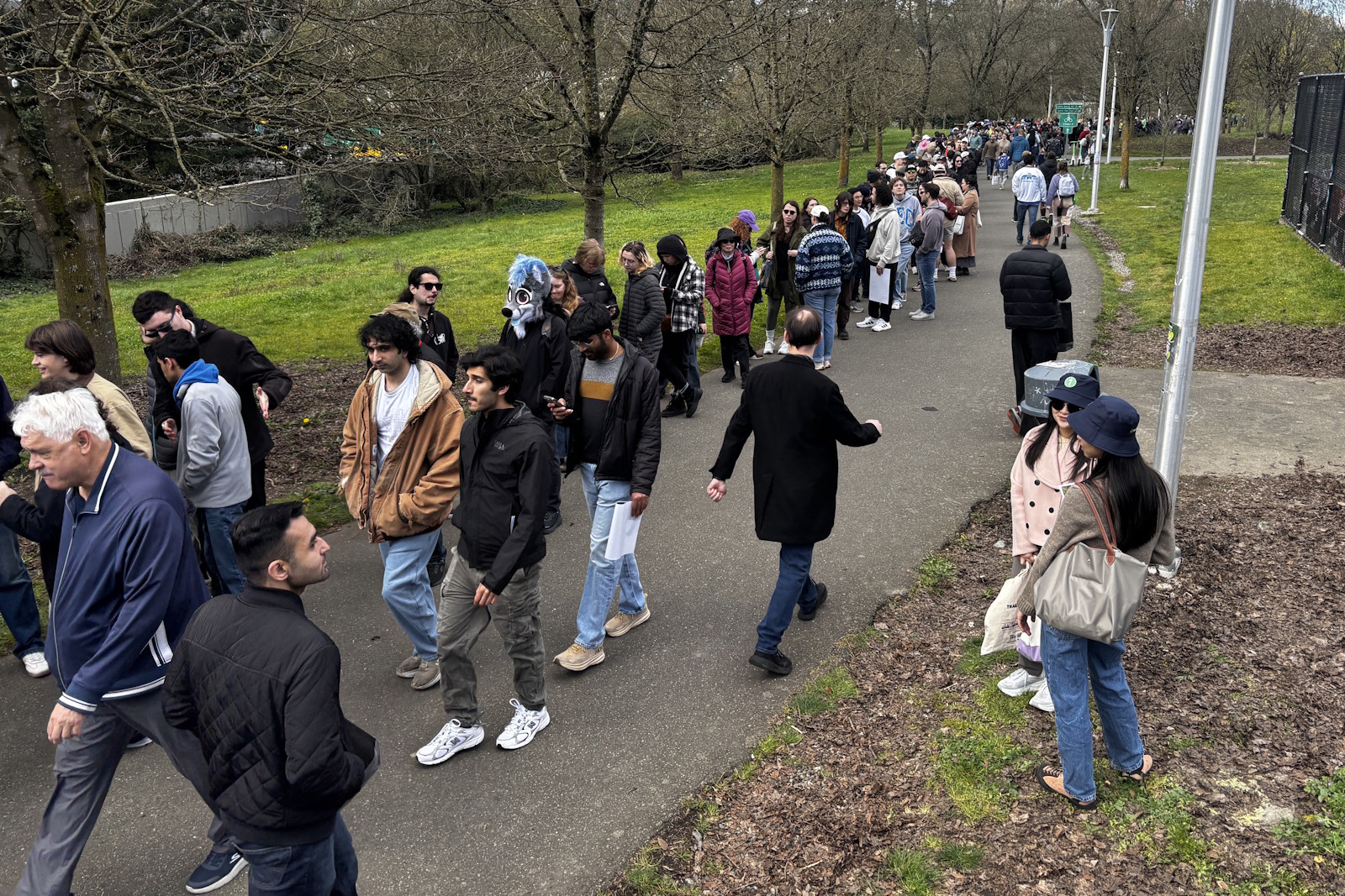 caption: The long line to board the train on opening day at Judkins Park Station