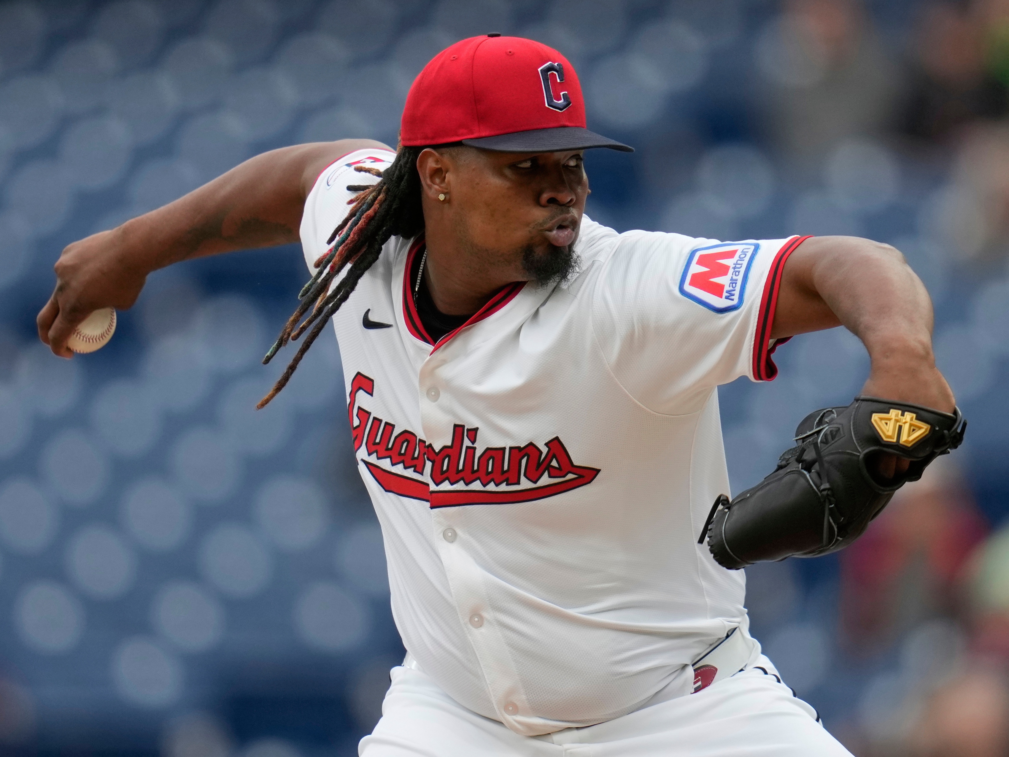 caption: Cleveland Guardians' Luis Ortiz pitches in the first inning of a baseball game against the Minnesota Twins in Cleveland on April 30.