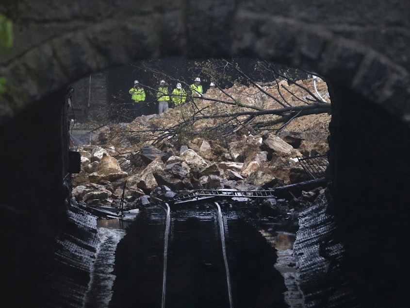 caption: A road collapsed onto train tracks in Baltimore, Md. in 2014 after heavy rain. The city is facing millions of dollars in infrastructure upgrades to cope with the effects of climate change.