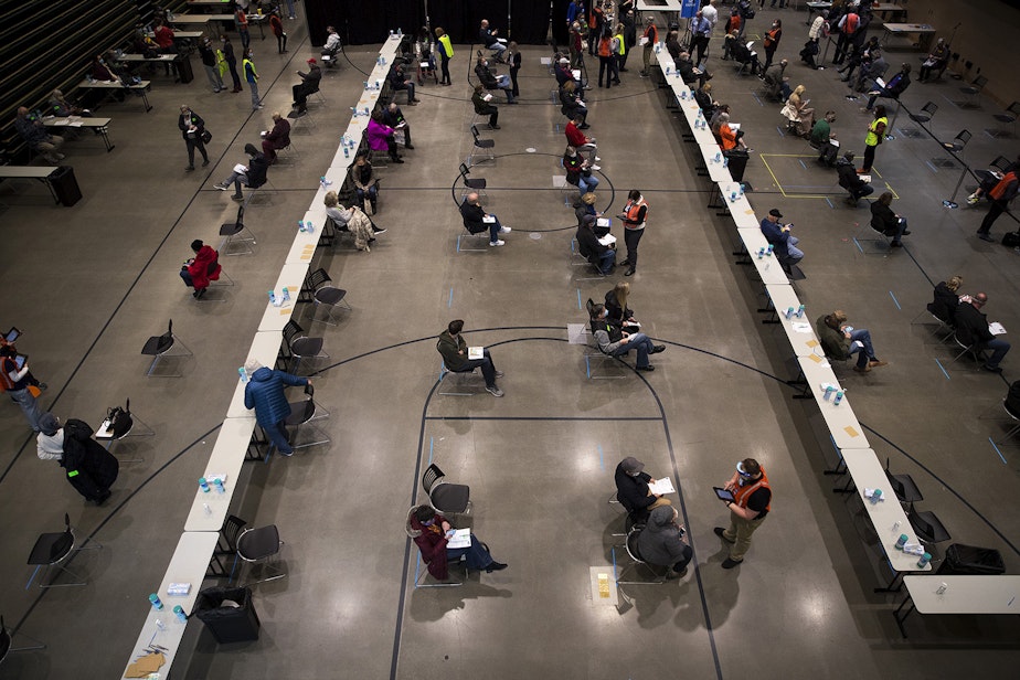 caption: People wait for 15 minutes after receiving the first dose of the Pfizer-BioNTech Covid-19 vaccine on Sunday, January 24, 2021, during a one-day pop up Covid-19 vaccine clinic at Amazon's headquarters in Seattle. 