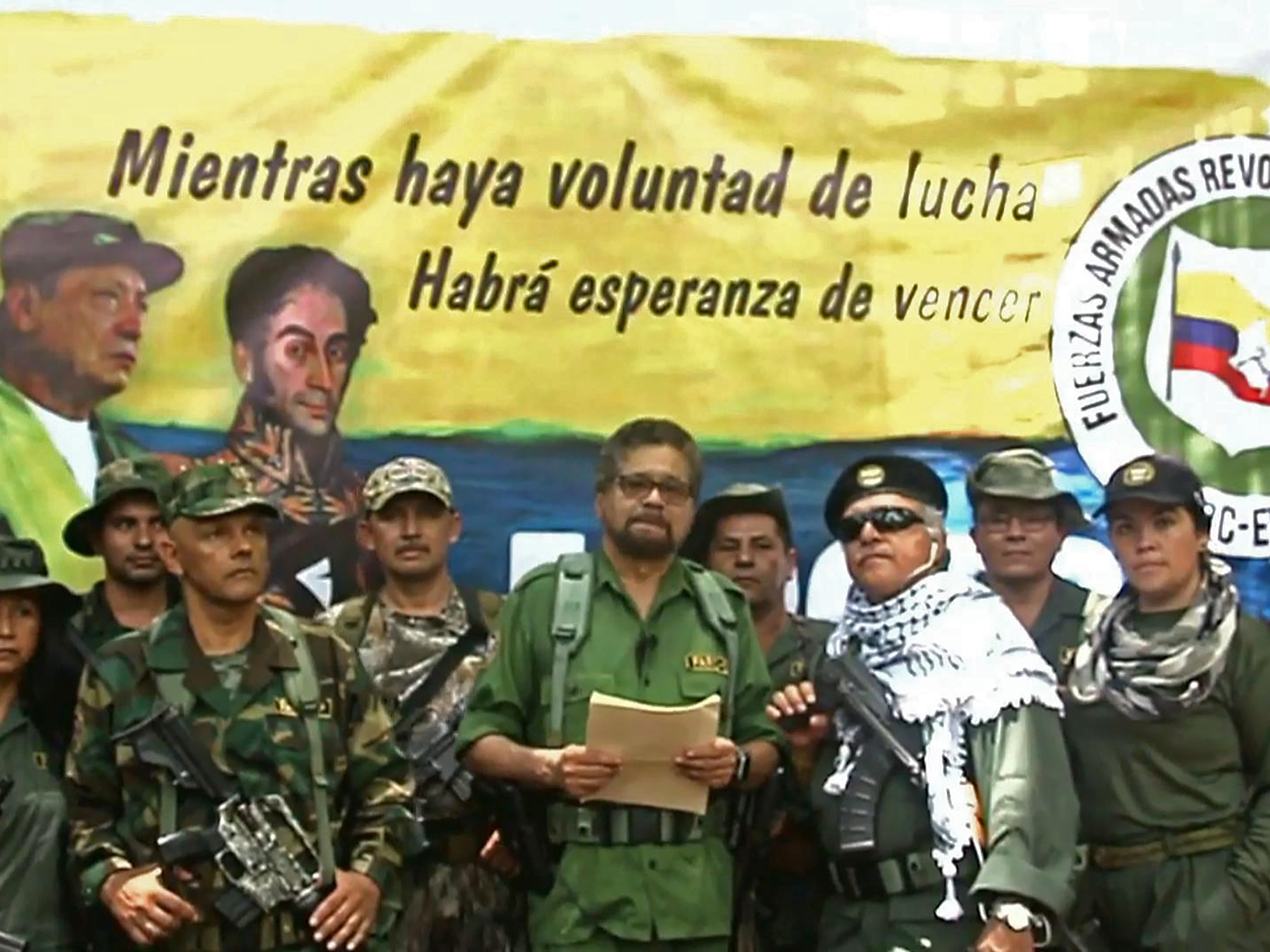 caption: In an image from a YouTube video released on Aug. 29, 2019, shows Former senior commander Iván Márquez (center) and fugitive rebel colleague, Jesús Santrich (wearing sunglasses), of the Revolutionary Armed Forces of Colombia at an undisclosed location announcing they are taking up arms again.