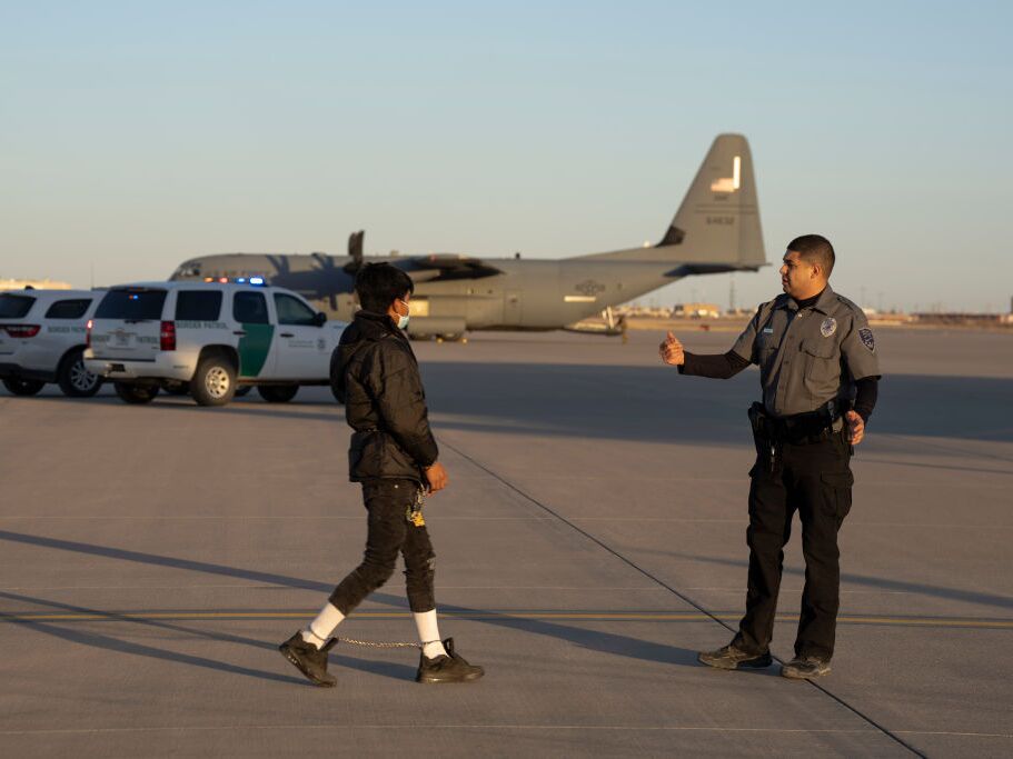 caption: An immigrant prepares to board a military removal flight last month at Fort Bliss, near El Paso, Texas.