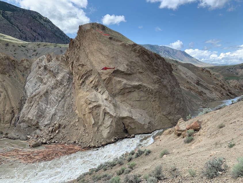 caption: A helicopter (see it?) hovers above the site of a rockslide and partial blockage of Canada's Fraser River.