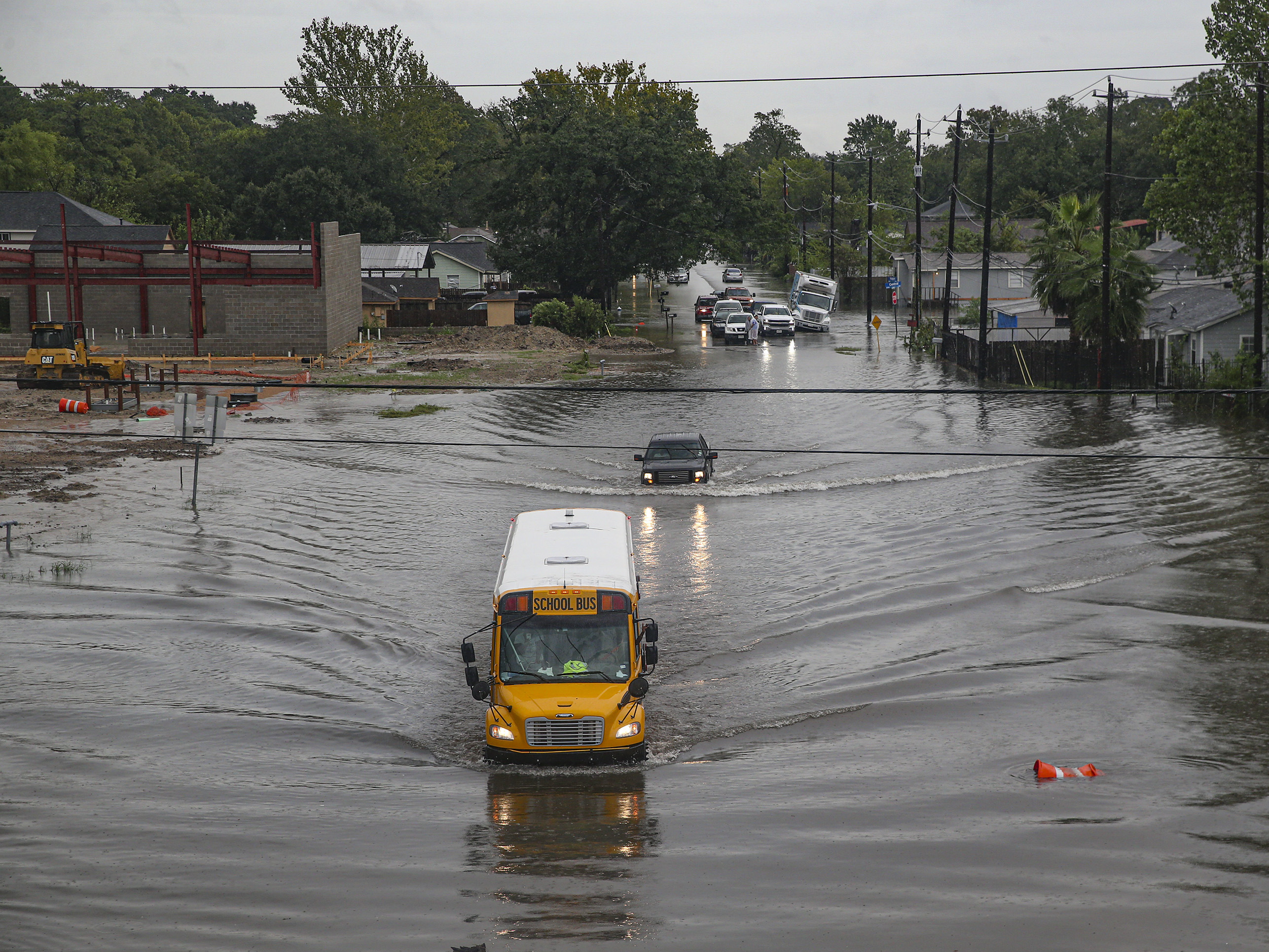 caption: A school bus makes its way through a flooded section of Hopper Road in Houston on Thursday. Texas Gov. Greg Abbott has declared much of southeast Texas disaster areas after heavy rain and flooding from the remnants of Tropical Depression Imelda.