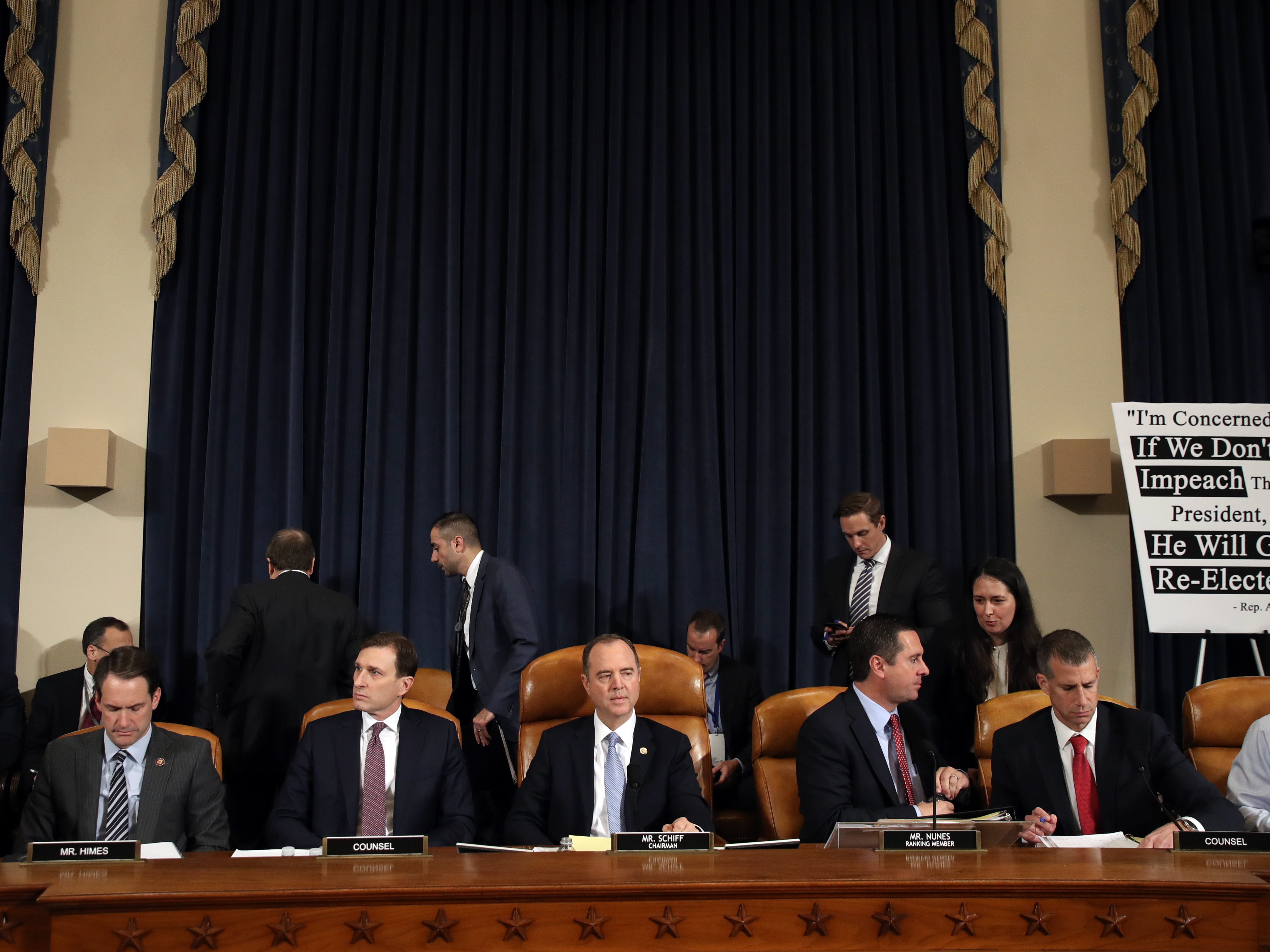 caption: Daniel Goldman, attorney and director of investigations with the House Intelligence Committee (second from left); committee Chairman Adam Schiff, D-Calif; ranking member Rep. Devin Nunes, R-Calif.; and Steve Castor, counsel for the minority, hold the first public hearing of the impeachment inquiry on Capitol Hill on Wednesday.