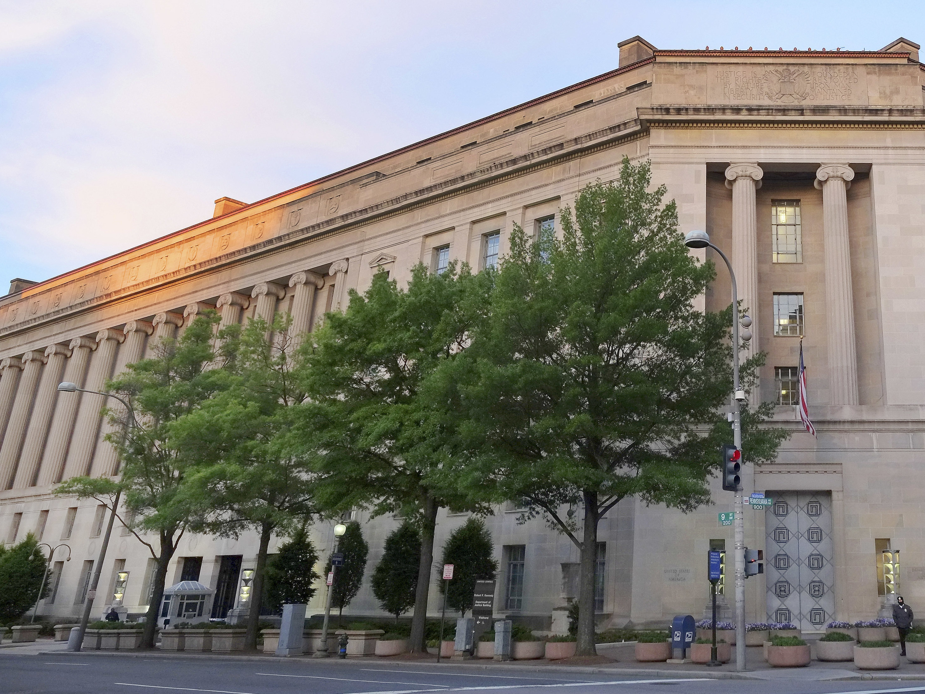 caption: Work at the Justice Department's headquarters in Washington has been slower than normal because of the government shutdown. Even so, it's calling attention to administration priorities about the Southern border.