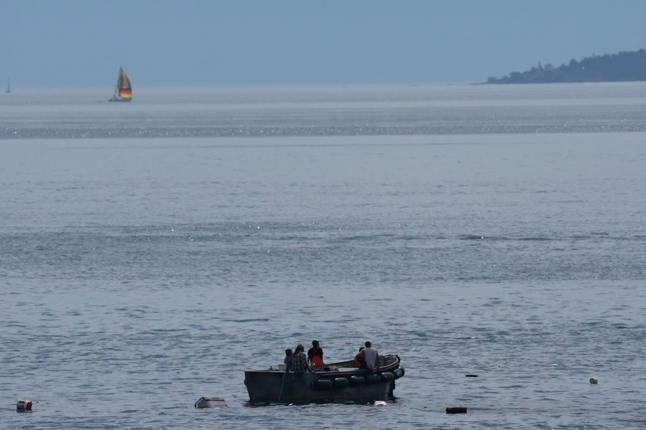 caption:  The crew of the Aleutian Isle await rescue in a skiff after their boat sank off San Juan Island on Aug. 12.