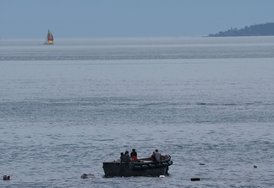 caption:  The crew of the Aleutian Isle await rescue in a skiff after their boat sank off San Juan Island on Aug. 12.