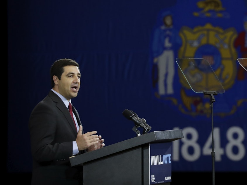 caption: Josh Kaul speaks at a rally on Oct. 26, 2018, in Milwaukee. His office has faced criticism for its investigation into the shooting of Jacob Blake.