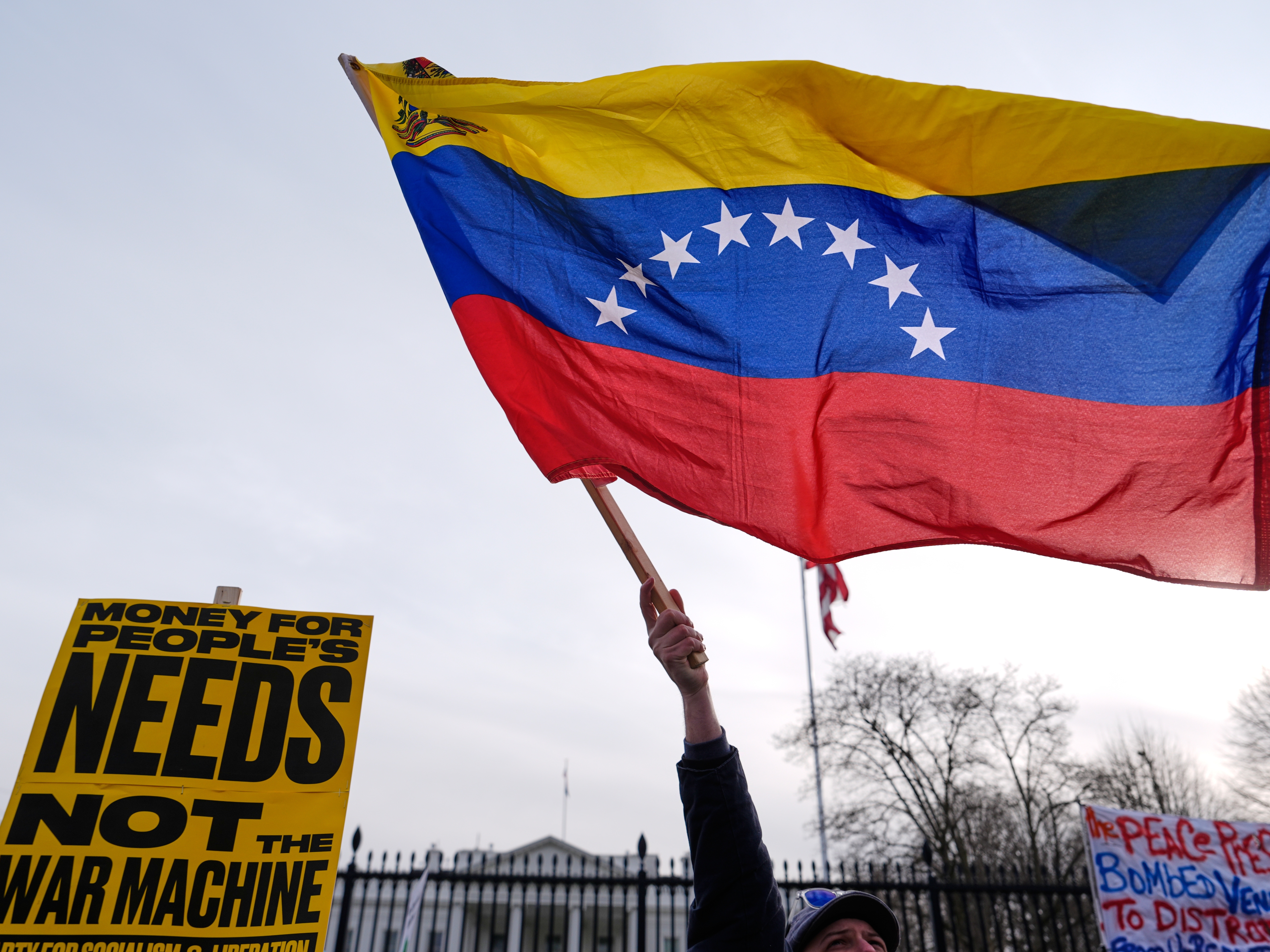 caption: Protesters rally outside the White House Saturday, Jan. 3, 2026, in Washington, after the U.S. captured Venezuelan President Nicolás Maduro and his wife in a military operation.