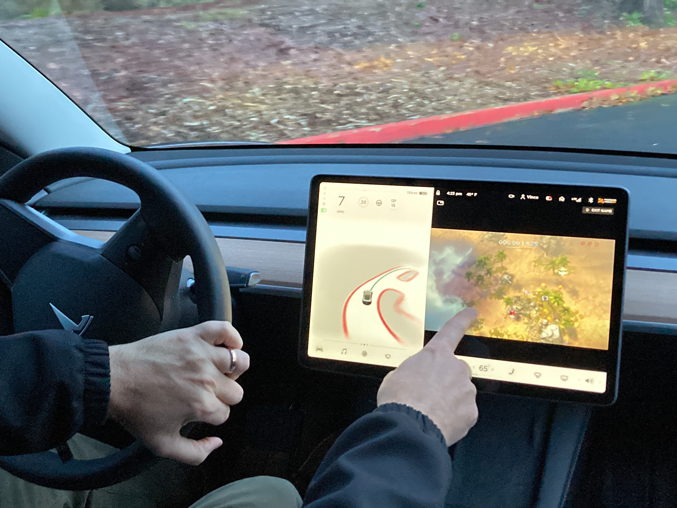 caption: Vince Patton, a new Tesla owner, demonstrates on Dec. 8, 2021, on a closed course in Portland, Ore., how he can play video games on the vehicle's console while driving. Under pressure from U.S. auto safety regulators, Tesla has agreed to stop allowing video games to be played on center touch screens while its vehicles are moving.