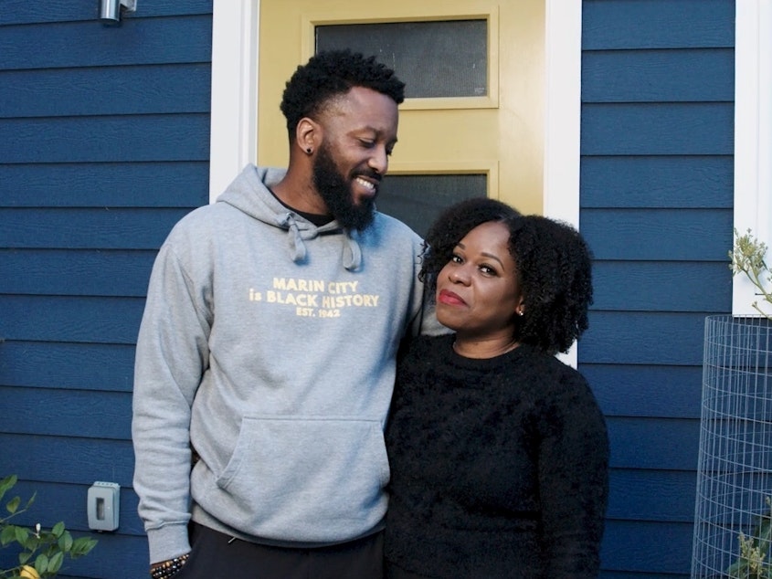 caption: Paul Austin and Tenisha Tate Austin stand in front of their renovated home in Marin City, Calif. The couple settled a federal housing discrimination lawsuit late last month.