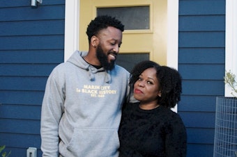 caption: Paul Austin and Tenisha Tate Austin stand in front of their renovated home in Marin City, Calif. The couple settled a federal housing discrimination lawsuit late last month.