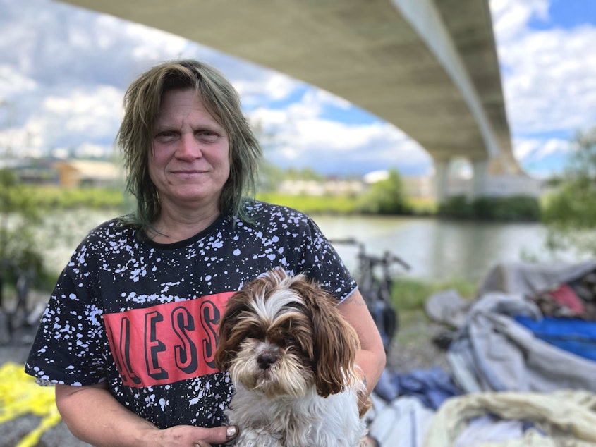 caption: Chris Sawyer with Rosy at her camp under State Route 509 in Tacoma