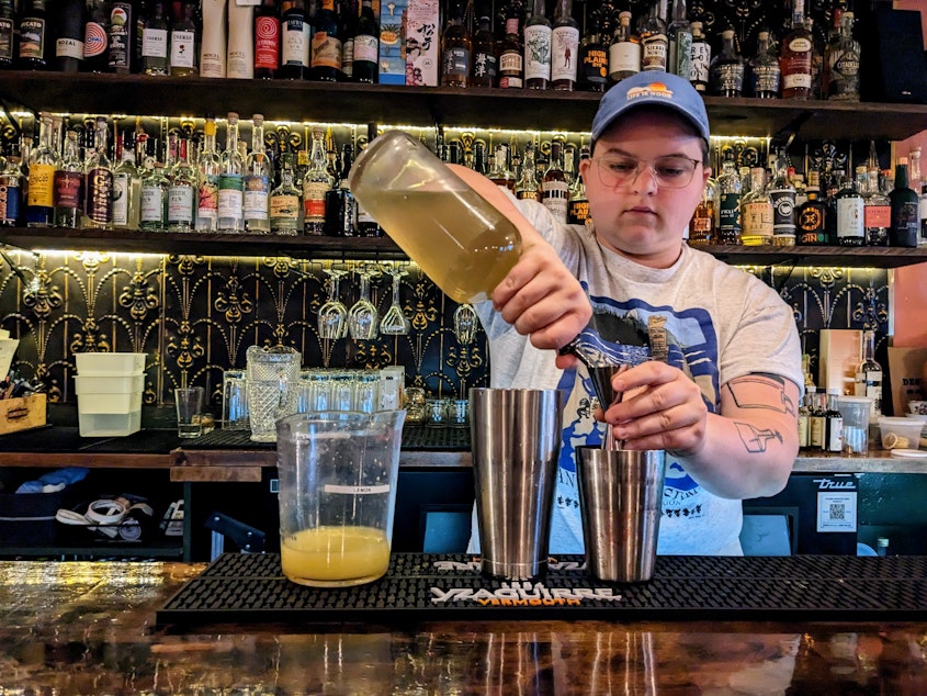 caption: Libby Huse pours drinks at Jude's, a co-op bar and restaurant in Rainier Beach. 