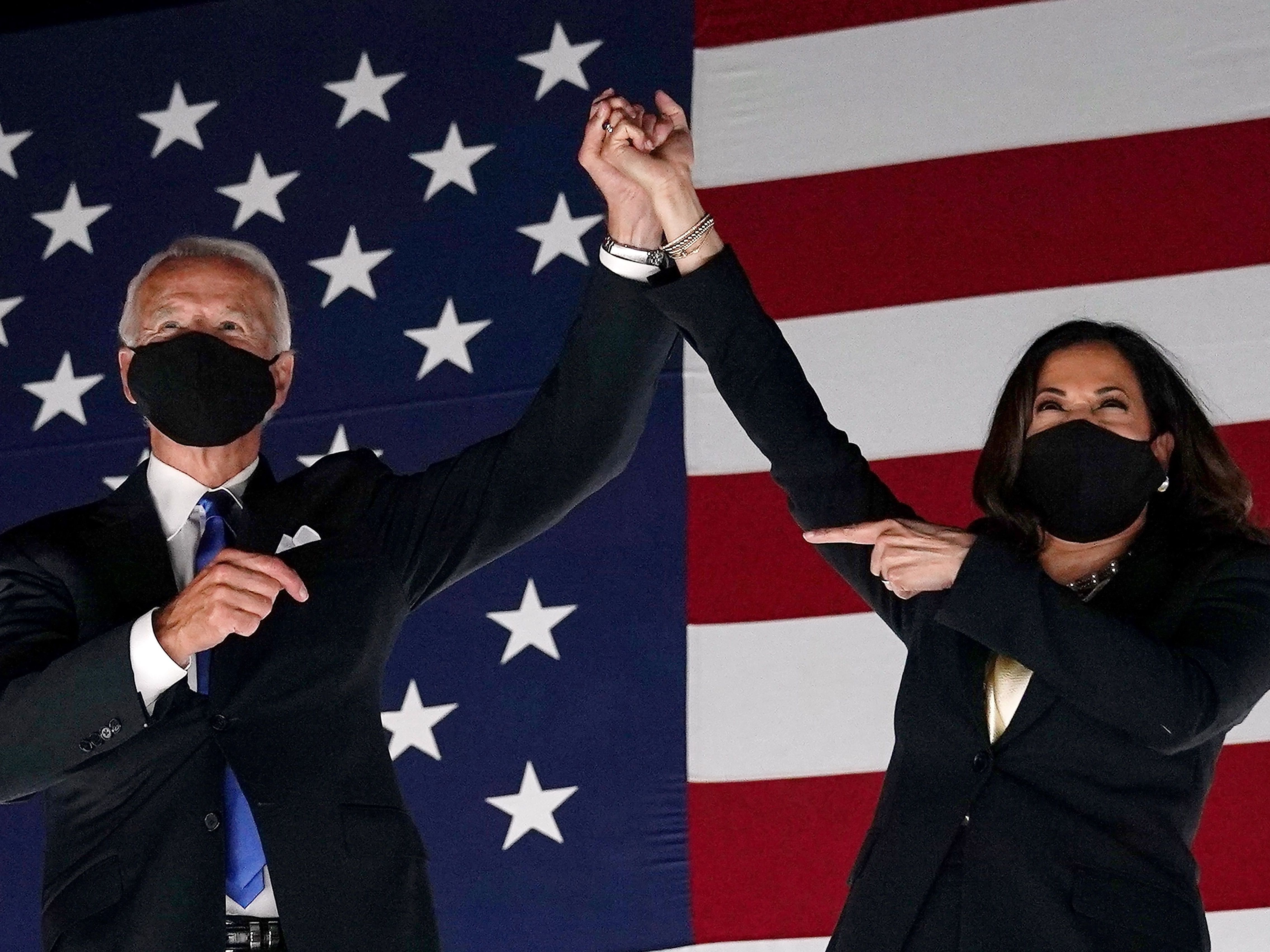 caption: Former vice-president and Democratic presidential nominee Joe Biden and Senator from California and Democratic vice presidential nominee Kamala Harris greet supporters outside the Chase Center in Wilmington, Delaware.