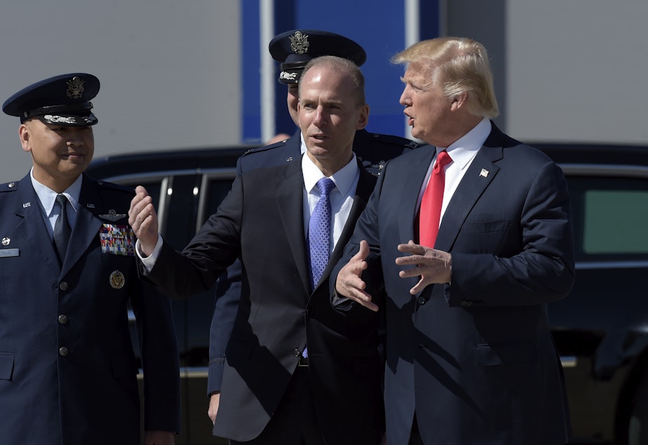 caption: President Donald Trump talks with Boeing CEO Dennis Muilenburg upon his arrival on Air Force One at Charleston International Airport in North Charleston, S.C., Friday, Feb. 17, 2017.