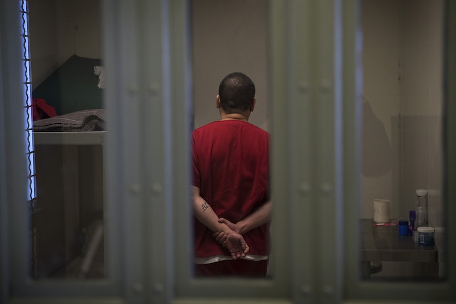 caption: A detainee in solitary at the Northwest Detention Center in Tacoma.