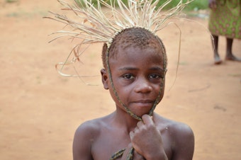 caption: A child from the Mbendjele people, a hunter-gatherer community that lives in the northern rainforests of the Republic of Congo. A new study found that children in this society have on average 8 caregivers in addition to the mother to provide hands-on attention.