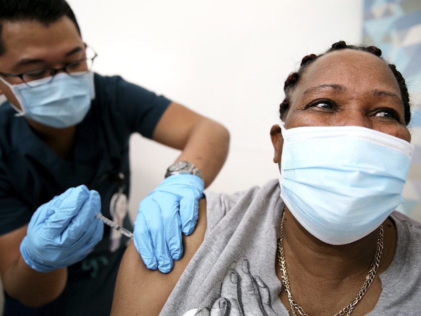 caption: An in-home care worker receives her first dose of the COVID-19 vaccine in February in Los Angeles, Calif.
