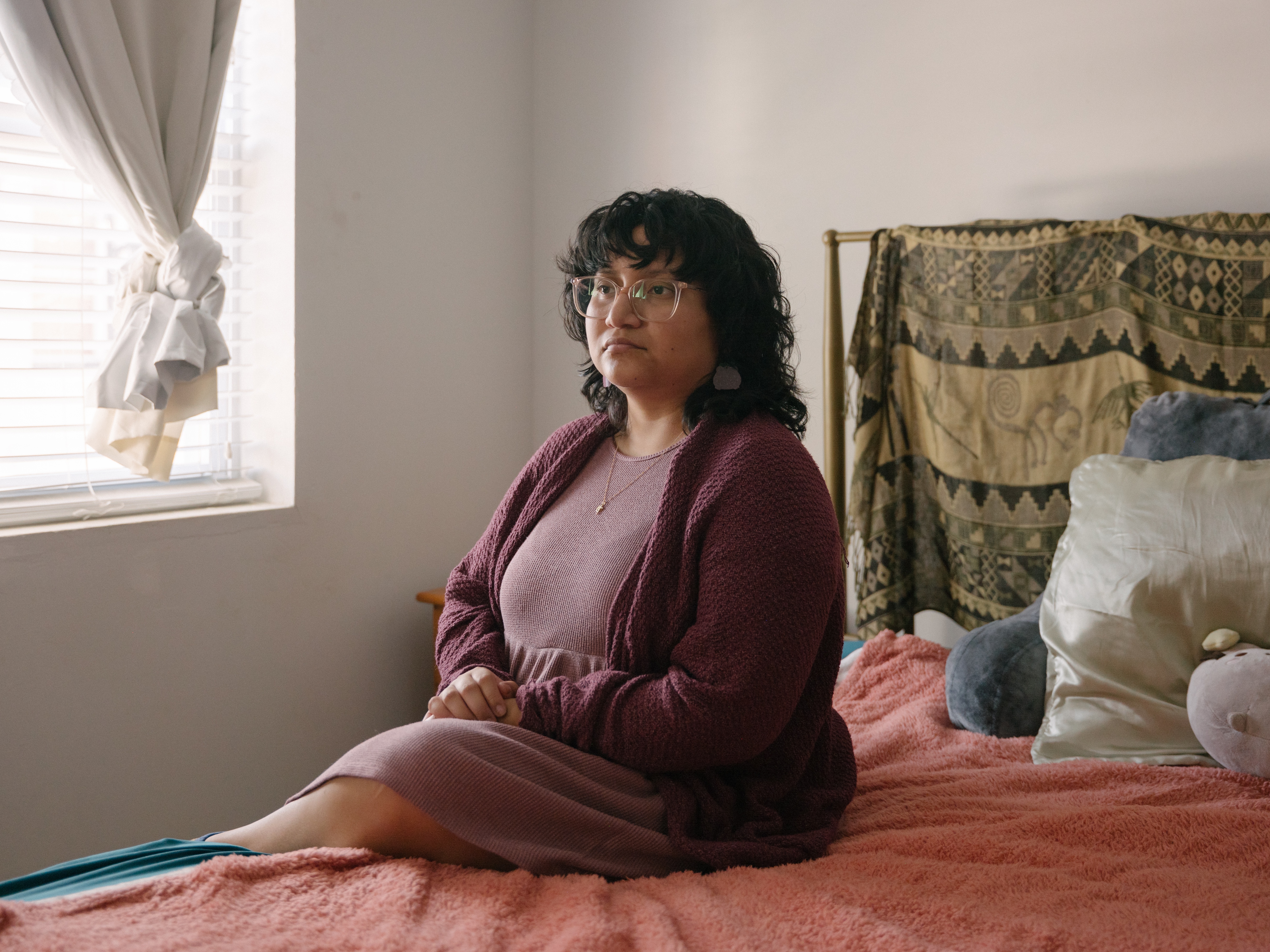 caption: Lourdes Monje, diagnosed with breast cancer at 25, represents the new generation of cancer survivors — a person who is younger, less financially secure, and has to navigate life after treatment. Monje, now 29, says they mourn the loss of the sense that life was "infinite."