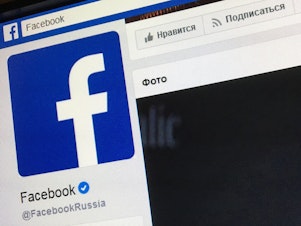 caption: A picture taken in Moscow in March 2018 shows the Russian language version of Facebook's about page, featuring the face of founder and CEO Mark Zuckerberg.