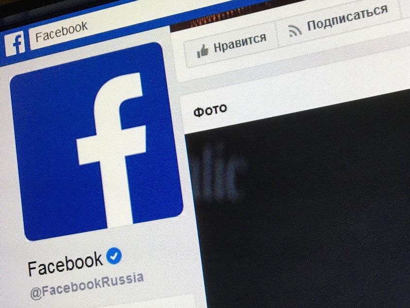 caption: A picture taken in Moscow in March 2018 shows the Russian language version of Facebook's about page, featuring the face of founder and CEO Mark Zuckerberg.