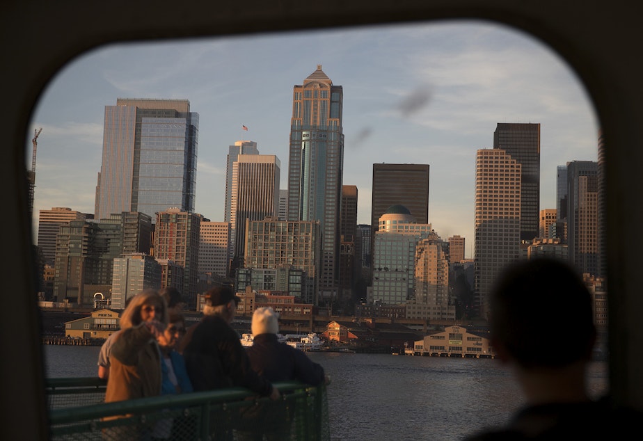 Ferry riders look toward downtown Seattle shortly before arriving from Bremerton on a ferry on Thursday, June 29, 2017, in Seattle.