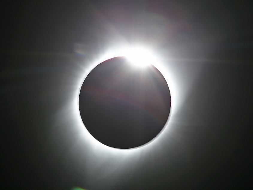 caption: The sun is shown in the first phase of a total eclipse in this photo taken in August 2017 from Grand Teton National Park outside Jackson, Wyo.