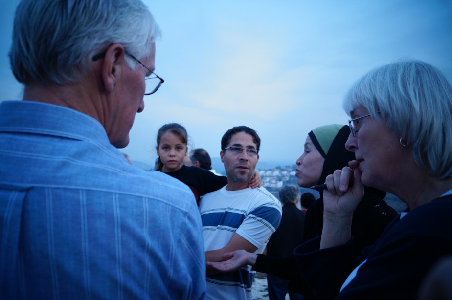 caption: Craig and Cindy Corrie meet with Palestinians in the West Bank as part of an Interfaith Peace Builders olive harvest delegation in October 2012.