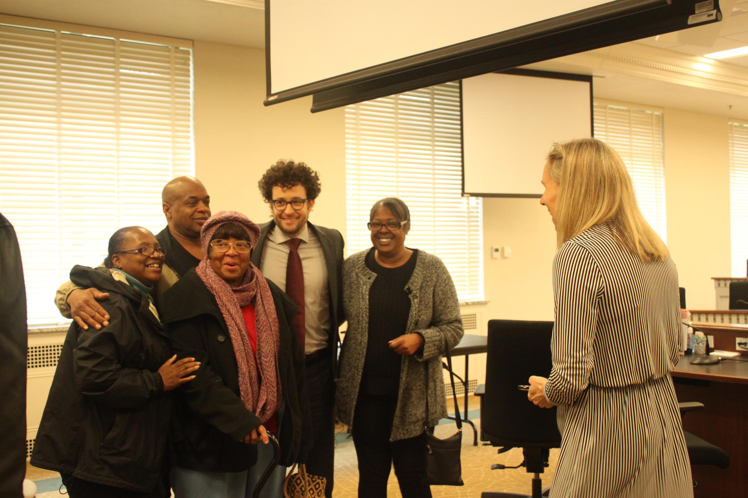 caption: Alana Ervin, left, poses with family members and lawyer Spencer Gheen for a celebratory photo after the state clemency board recommends early release for family member Prenters Broughton, who awaits final approval from Gov. Jay Inslee. CREDIT: MAX WASSERMAN