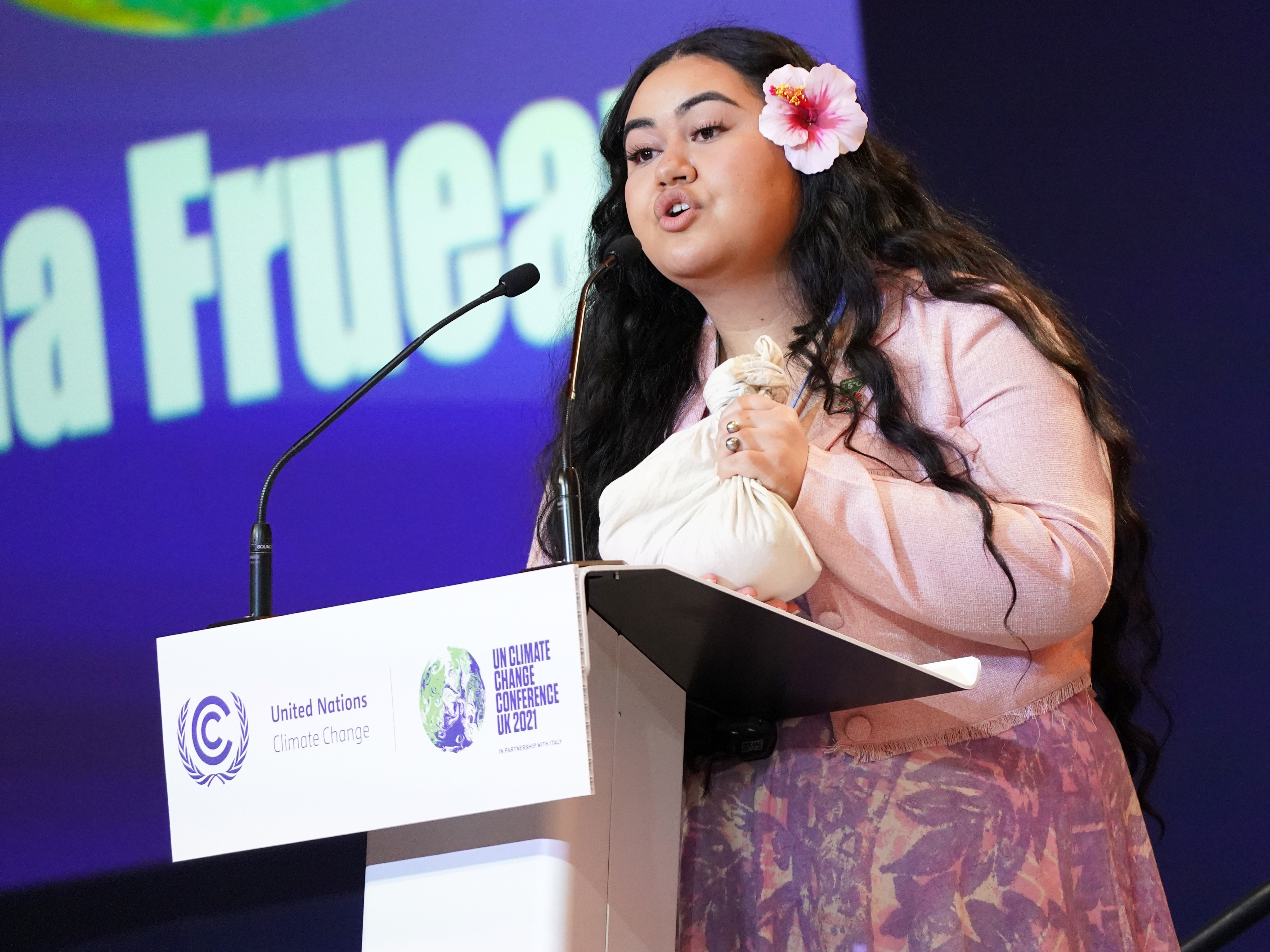 caption: Brianna Fruean, a Samoan member of the Pacific Climate Warriors, speaks at the COP26 climate summit in Glasgow, Scotland, on Tuesday.