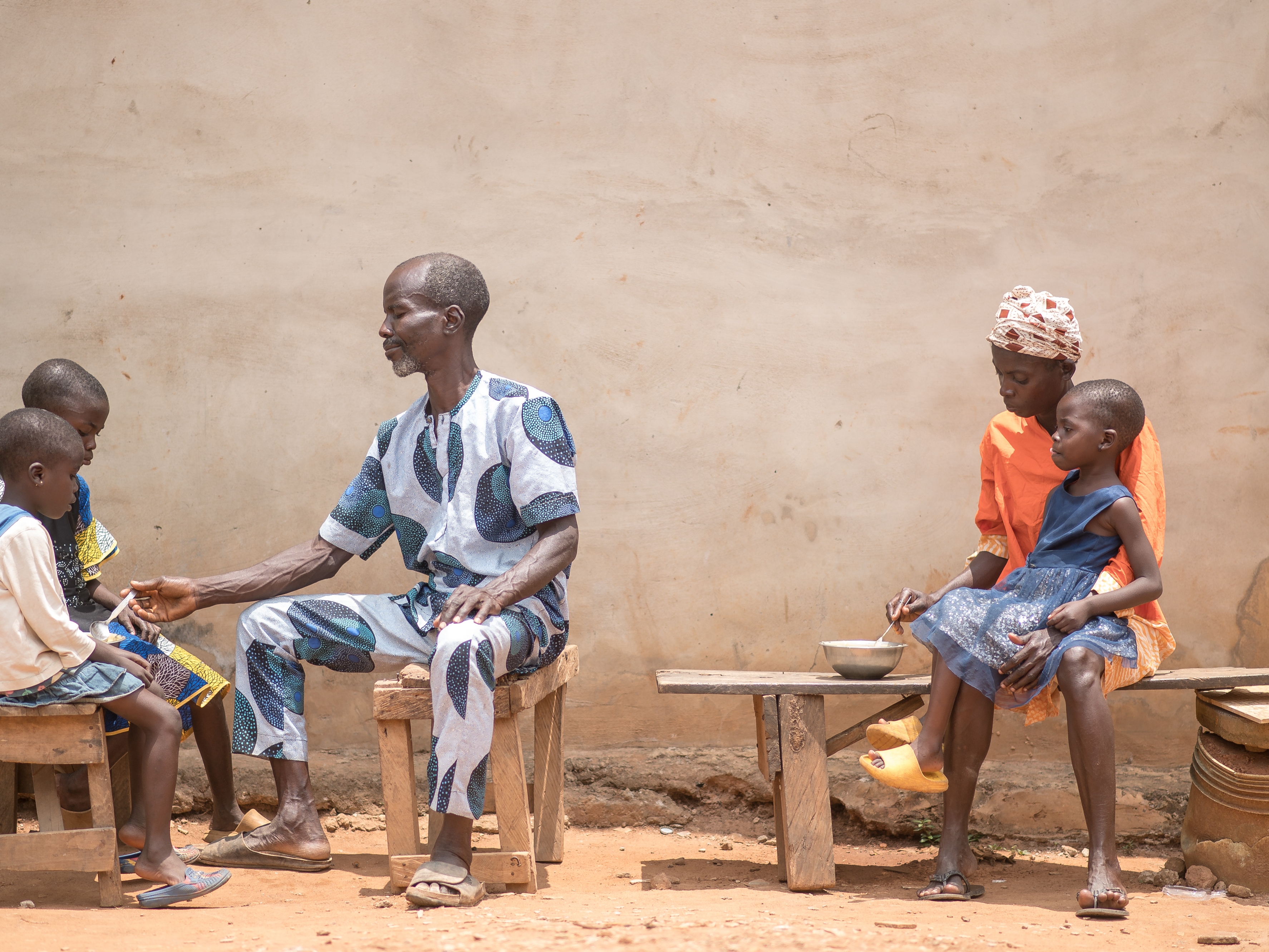 caption: Toyin Salami of Lagos, Nigeria, with her 4-year-old daughter, Kudirat. Her husband, Saheed, tends to two of their other children. "It's hard to get food, let alone nutritious food," she says.
