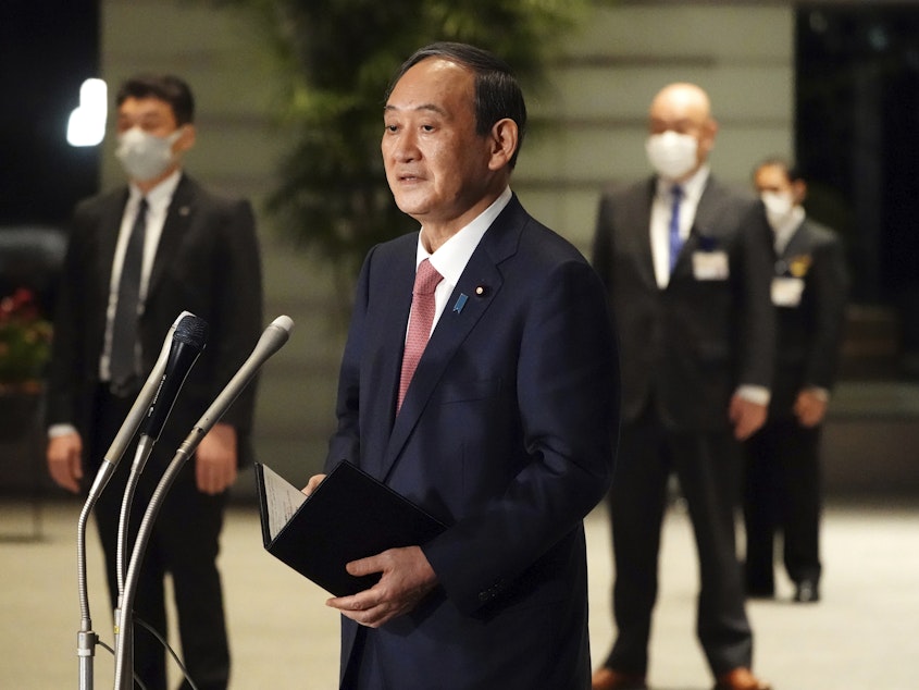 caption: Japanese Prime Minister Yoshihide Suga speaks to media in Tokyo this month. Suga will take part in a Friday summit meeting with President Biden, the first foreign leader to meet the president face to face.