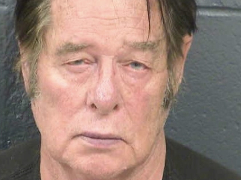 caption: Larry Mitchell Hopkins appears in a police booking photo taken in Las Cruces, N.M., on April 20. Hopkins made his initial court appearance Monday, on charges of possession of firearms by a felon.