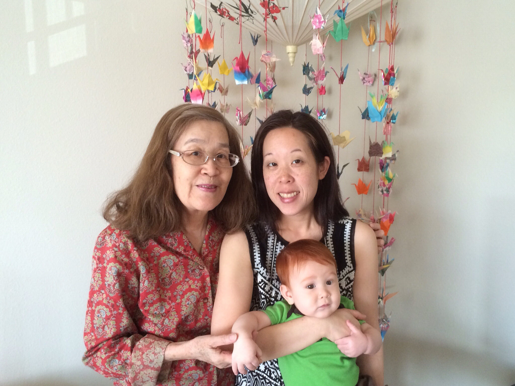 caption: The writer with her mother and son. 