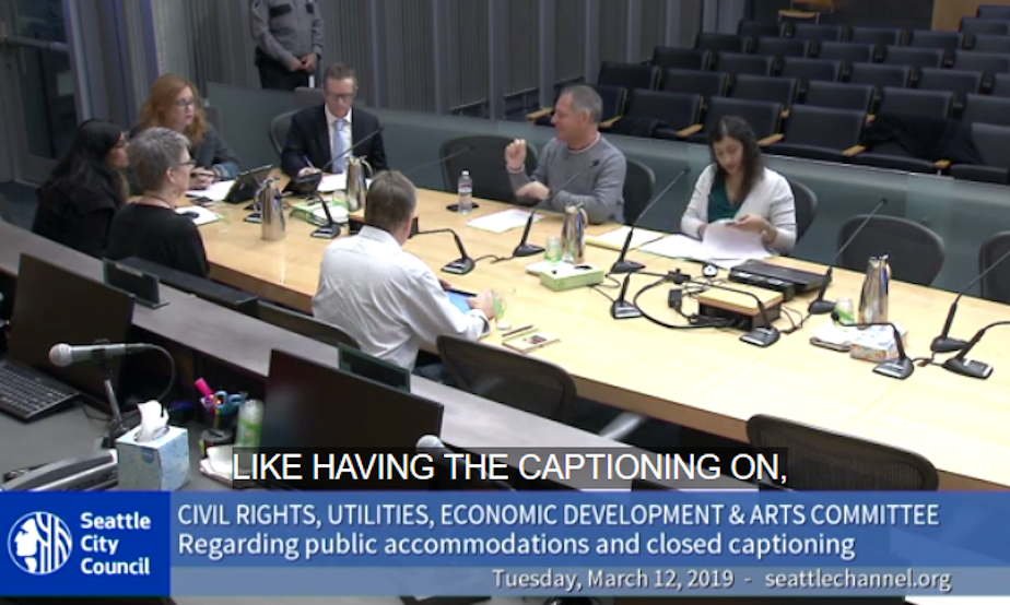 caption: Seattle city council committee discussion on closed captions
