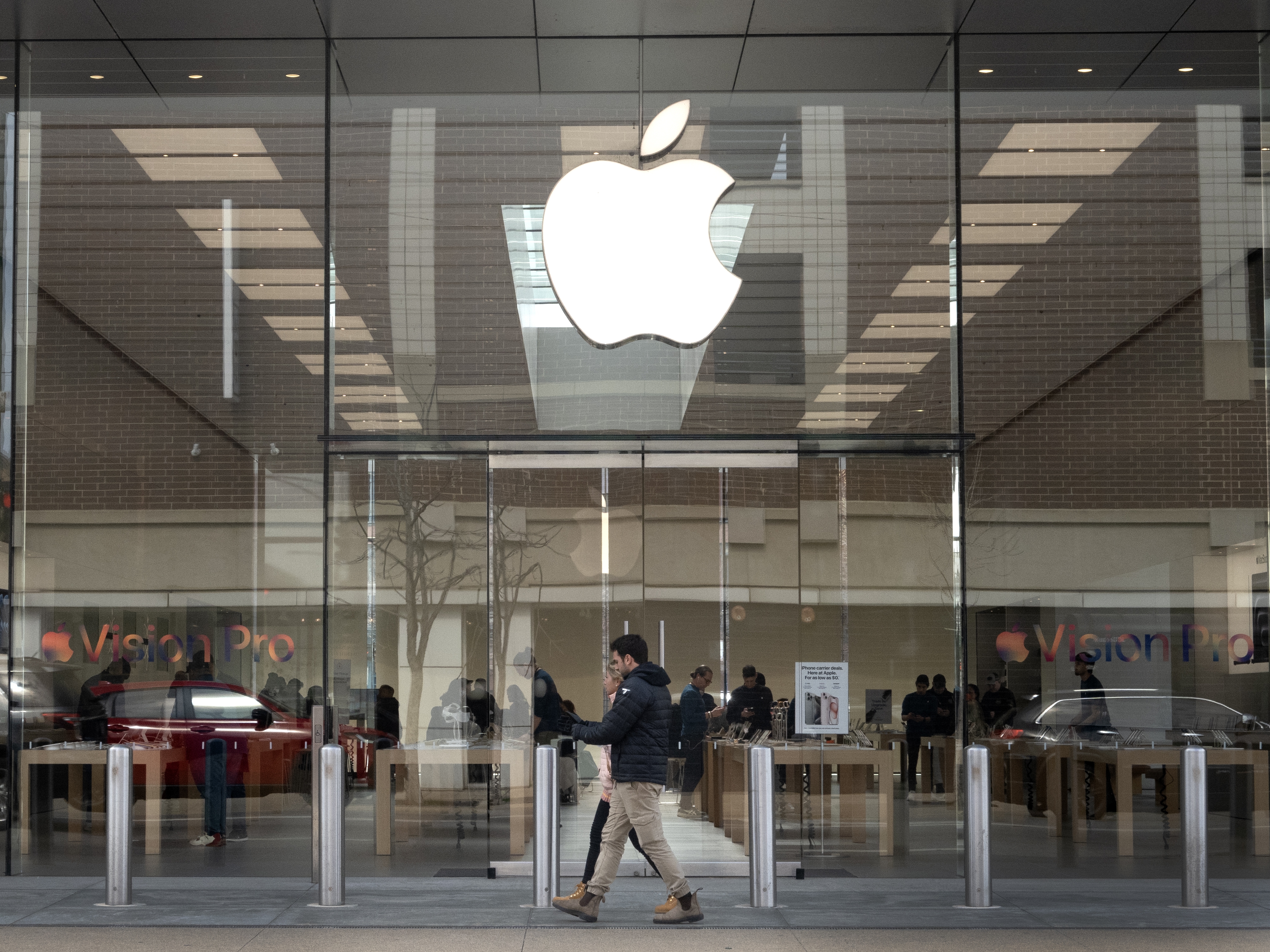 caption: The Consumer Finance Protection Bureau has fined Apple and Goldman Sachs $89 million. Pictured is the Apple logo hanging in front of an Apple store in Chicago in March.