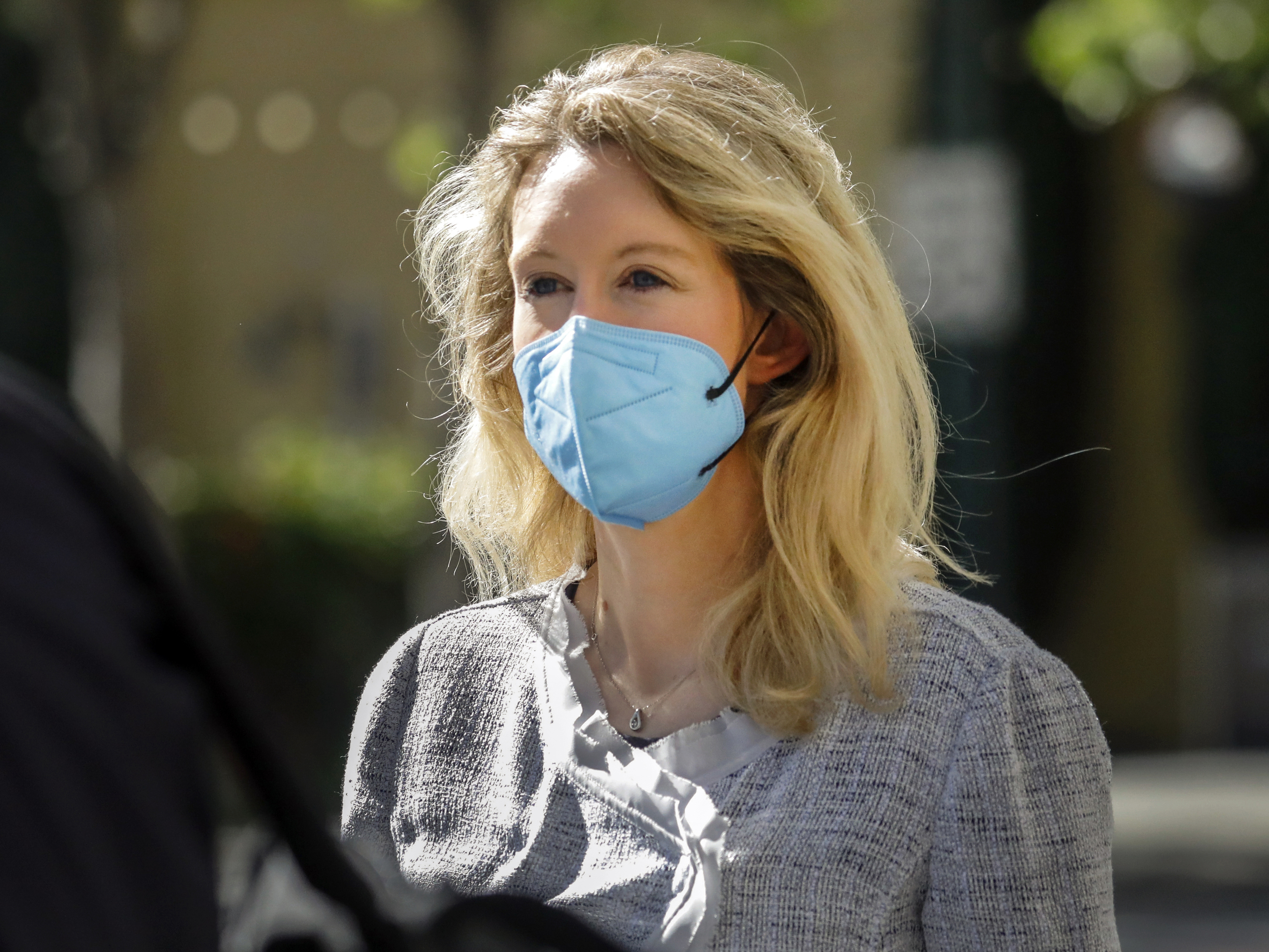 caption: Elizabeth Holmes, pictured in May 2021, took the stand on Friday.