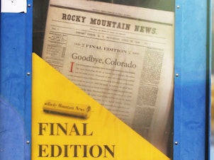 caption: A copy of the final edition of the Rocky Mountain News sits in a newspaper box on a street corner in Denver, Colorado.