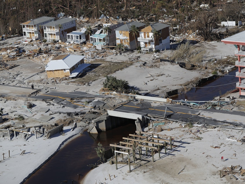 caption: A bridge damaged by Hurricane Michael can be seen Friday in Mexico Beach, Fla. The most powerful hurricane ever known to have hit the Florida Panhandle has left transportation and communication infrastructure in shambles, slowing relief efforts.