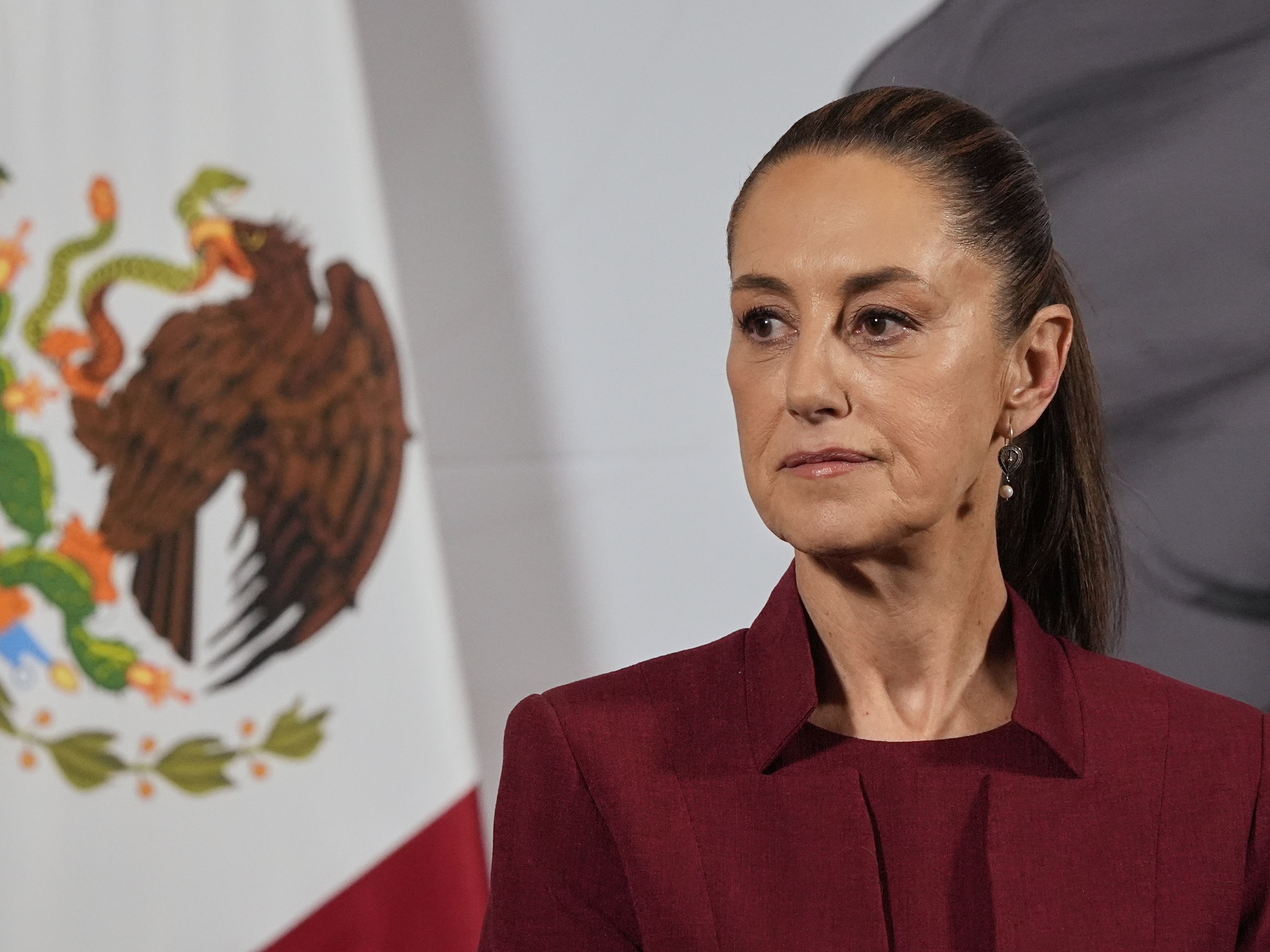 caption: Mexican President Claudia Sheinbaum attends her morning press conference at the National Palace in Mexico City, April 2, 2025.