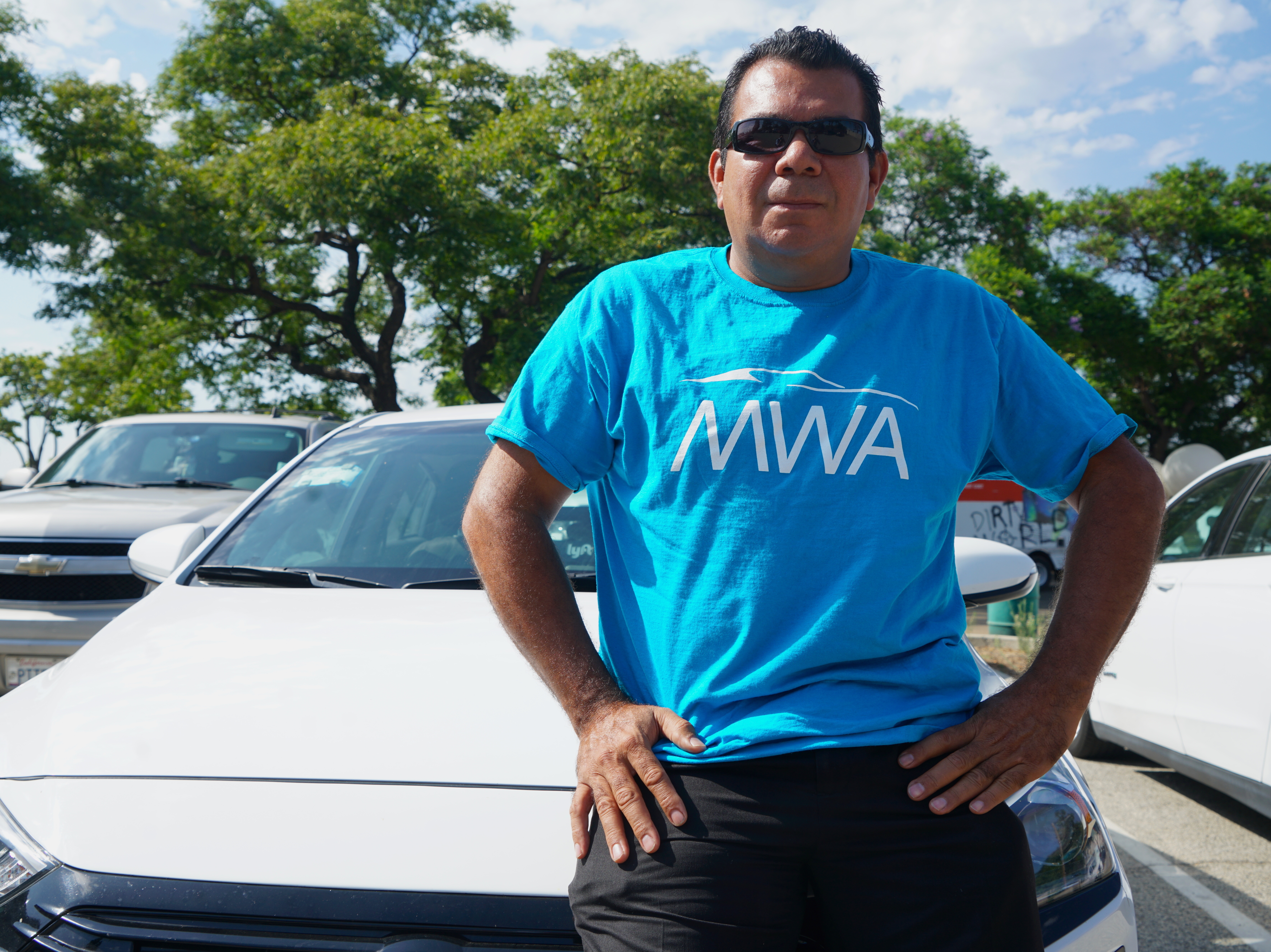 caption: Leonardo Diaz lives in Los Angeles and drives for Uber and Lyft. He says he misses employee health and paid leave benefits he used to receive when he worked as a valet.