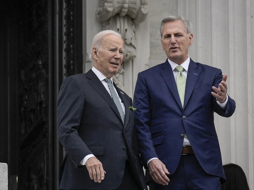 caption: President Biden and House Speaker Kevin McCarthy, seen here speaking at the U.S. Capitol on March 17, agreed to a deal that would raise the debt ceiling.