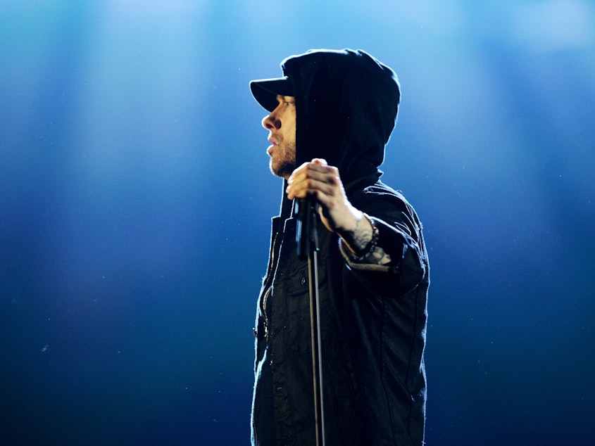 caption: Eminem performs on stage during the MTV European Music Awards in 2017.