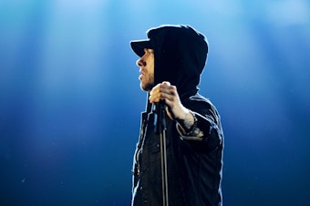 caption: Eminem performs on stage during the MTV European Music Awards in 2017.