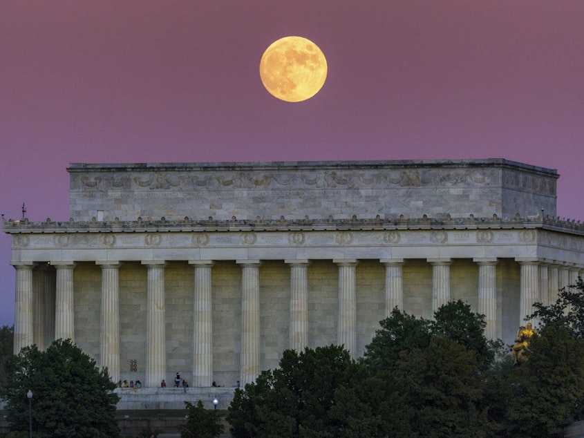 caption: The full moon, also called the Beaver Moon, rises above the Lincoln Memorial at sunset in Washington, Monday, Nov. 7, 2022.