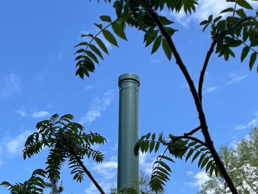 caption: A smokestack above the University of Washington's gas-burning steam plant during a heat wave in Seattle on May 15, 2023. 