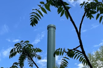 caption: A smokestack above the University of Washington's gas-burning steam plant during a heat wave in Seattle on May 15, 2023. 