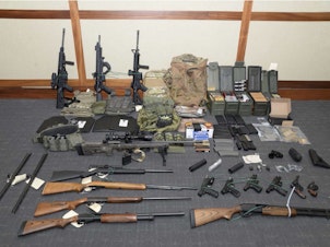 caption: Firearms and ammunition found at Christopher Hasson's residence.